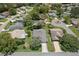 Aerial view of neighborhood showcasing mature trees, winding streets, and well-maintained landscaping at 2486 Deer Trail Ln, Spring Hill, FL 34606