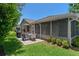 Backyard with a screened in lanai and a patio with outdoor furniture at 2486 Deer Trail Ln, Spring Hill, FL 34606