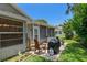 Back patio with grill, chairs and table creating an inviting outdoor space at 2486 Deer Trail Ln, Spring Hill, FL 34606