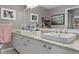 This bathroom features double sinks, granite countertops, modern fixtures, and decorative mirrors at 2486 Deer Trail Ln, Spring Hill, FL 34606