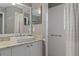 Bathroom features granite countertops, a rectangle sink, decorative mirrors, and shower at 2486 Deer Trail Ln, Spring Hill, FL 34606