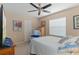 This bedroom has a ceiling fan, and a window with blinds at 2486 Deer Trail Ln, Spring Hill, FL 34606