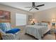 Bedroom featuring a ceiling fan, window with blinds, a chair, and neutral walls at 2486 Deer Trail Ln, Spring Hill, FL 34606