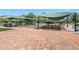 Well-maintained bocce ball court featuring shaded seating and a beautifully landscaped recreation area at 2486 Deer Trail Ln, Spring Hill, FL 34606