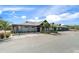 Attractive clubhouse entrance featuring stone accents and ample parking at 2486 Deer Trail Ln, Spring Hill, FL 34606