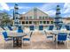 Inviting community pool surrounded by comfortable lounge chairs, tables with umbrellas, and a spacious deck at 2486 Deer Trail Ln, Spring Hill, FL 34606