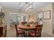 Bright dining room featuring a wooden table with chairs and modern chandelier at 2486 Deer Trail Ln, Spring Hill, FL 34606