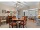 Dining room featuring a round wood table, seating for four, and unique lighting fixture at 2486 Deer Trail Ln, Spring Hill, FL 34606