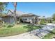 Charming exterior view featuring well-maintained landscaping, stone pillar accents, and a welcoming entryway at 2486 Deer Trail Ln, Spring Hill, FL 34606