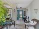 Inviting front porch with seating, decorative accents, and a stylish blue front door at 2486 Deer Trail Ln, Spring Hill, FL 34606