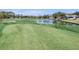 Scenic golf course with a pond, surrounded by lush greenery at 2486 Deer Trail Ln, Spring Hill, FL 34606