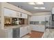 Modern kitchen with white cabinets, granite countertops, and stainless steel appliances at 2486 Deer Trail Ln, Spring Hill, FL 34606