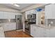 Bright kitchen with stainless steel appliances, white cabinets, wood floors, and stylish countertops at 2486 Deer Trail Ln, Spring Hill, FL 34606