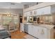 Kitchen with granite countertops, white cabinets and eat-in kitchen table surrounded by windows at 2486 Deer Trail Ln, Spring Hill, FL 34606