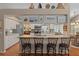 Kitchen with breakfast bar, white cabinetry, stone countertops and stainless steel appliances at 2486 Deer Trail Ln, Spring Hill, FL 34606
