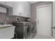 This laundry room features an LG washer and dryer, cabinets, and a sink at 2486 Deer Trail Ln, Spring Hill, FL 34606