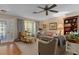Comfortable living room with floral armchair, patterned curtains, and ample natural light at 2486 Deer Trail Ln, Spring Hill, FL 34606