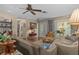 Open living room with sofa, patterned drapes, and doorway views to dining room at 2486 Deer Trail Ln, Spring Hill, FL 34606