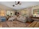 Relaxing living room with vaulted ceilings, ceiling fans, comfortable seating, and tasteful décor at 2486 Deer Trail Ln, Spring Hill, FL 34606