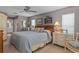 This bedroom features stylish décor, carpet flooring, a ceiling fan, and ensuite bath access at 2486 Deer Trail Ln, Spring Hill, FL 34606