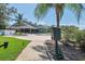 Community pool with lounge chairs and shade, set amidst lush landscaping near the clubhouse at 2486 Deer Trail Ln, Spring Hill, FL 34606