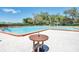 Enjoy the community pool with an adjacent table for convenience at 2486 Deer Trail Ln, Spring Hill, FL 34606