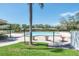 Resort-style community pool featuring comfortable seating, landscaped surroundings, and clear blue water at 2486 Deer Trail Ln, Spring Hill, FL 34606