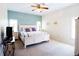 Bright bedroom with a queen bed, ceiling fan, and white furniture at 2542 Sandy Hill Ct, Holiday, FL 34691