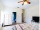 Comfortable bedroom with a white dresser, ceiling fan, and ensuite bathroom at 2542 Sandy Hill Ct, Holiday, FL 34691