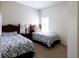 Cozy bedroom with two twin beds and a window with plantation shutters at 2542 Sandy Hill Ct, Holiday, FL 34691