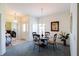 Bright dining room featuring a glass table, chandelier, and neutral-toned carpet at 2542 Sandy Hill Ct, Holiday, FL 34691