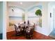 Unique dining area featuring a beach-themed mural, wooden chairs, and glass table at 2542 Sandy Hill Ct, Holiday, FL 34691