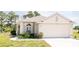 Charming single-story home with a two-car garage, manicured lawn and mature landscaping at 2542 Sandy Hill Ct, Holiday, FL 34691