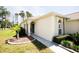 Well-maintained home exterior with lush landscaping, a charming entrance, and an arched portico at 2542 Sandy Hill Ct, Holiday, FL 34691