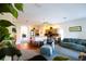 Open-concept living room and kitchen with island seating and comfortable furnishings at 2542 Sandy Hill Ct, Holiday, FL 34691