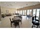 Well-lit lounge area with seating and tables, perfect for community gatherings and relaxation at 2542 Sandy Hill Ct, Holiday, FL 34691