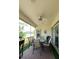 Covered outdoor patio with a ceiling fan and a table with chairs at 2542 Sandy Hill Ct, Holiday, FL 34691