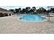 Large pool featuring inviting clear blue water and spacious patio area for lounging and recreation at 2542 Sandy Hill Ct, Holiday, FL 34691