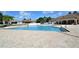 Community pool area offers a refreshing escape with ample seating and a tranquil atmosphere for relaxation and leisure at 2542 Sandy Hill Ct, Holiday, FL 34691