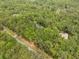 Aerial view highlighting neighborhood homes among dense trees, providing a serene and private setting at 27091 Country Oak Dr, Brooksville, FL 34602