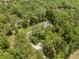 Aerial view of a home surrounded by lush, mature trees and greenery at 27091 Country Oak Dr, Brooksville, FL 34602