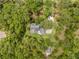 This shot of the house shows its long driveway and location amongst mature trees creating a secluded and private area at 27091 Country Oak Dr, Brooksville, FL 34602