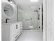 A bright bathroom featuring a walk-in shower with white tile and modern fixtures at 27091 Country Oak Dr, Brooksville, FL 34602