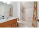 Bright bathroom featuring a shower-tub combo, single sink vanity, and neutral finishes at 27091 Country Oak Dr, Brooksville, FL 34602