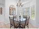 Bright dining area with a glass table, stylish chairs, and views of the backyard and pool at 27091 Country Oak Dr, Brooksville, FL 34602