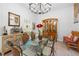 Elegant dining room featuring a glass table, wicker chairs, a chandelier, and decorative accents at 27091 Country Oak Dr, Brooksville, FL 34602