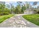 Spacious driveway leading to a three car garage and additional outbuilding at 27091 Country Oak Dr, Brooksville, FL 34602