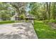 Spacious house with a long driveway and lush green lawn at 27091 Country Oak Dr, Brooksville, FL 34602