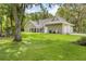 View of the house with a well-manicured lawn and attached garage at 27091 Country Oak Dr, Brooksville, FL 34602