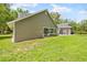 The back of a charming house features a sunroom and lush green lawn at 27091 Country Oak Dr, Brooksville, FL 34602